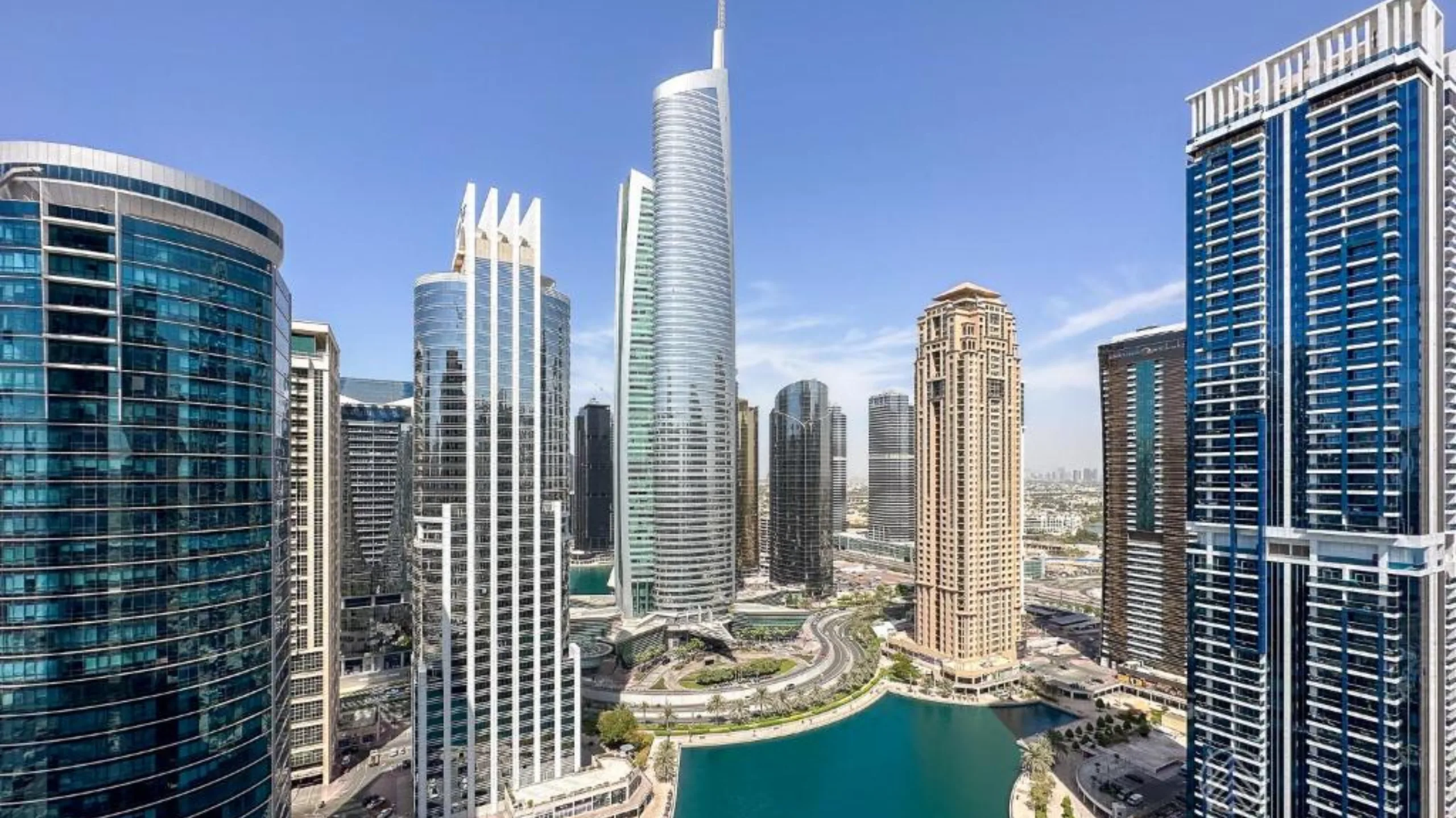 Jumeirah Lakes Towers (JLT), Dubai — DMCC free zone district: glass towers around the JLT lake with Almas Tower at the centre